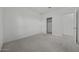 Bedroom with neutral carpet, white walls, closet, and a door leading to another room at 2937 E Lawndale Ct, Gilbert, AZ 85298