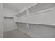 Spacious walk-in closet with multiple shelves and hanging rods for optimal organization at 2937 E Lawndale Ct, Gilbert, AZ 85298