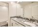 Modern bathroom with double sinks, granite countertop, and a separate tub at 29460 N 123Rd Gln, Peoria, AZ 85383