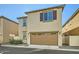 Tan two-story house with a brown garage door at 29460 N 123Rd Gln, Peoria, AZ 85383