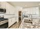 Kitchen with white cabinets, granite countertops, and walk-in pantry at 29460 N 123Rd Gln, Peoria, AZ 85383