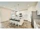 Modern kitchen with white cabinets, granite island, and stainless steel appliances at 29460 N 123Rd Gln, Peoria, AZ 85383
