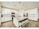 Modern kitchen with white cabinets, granite island, and stainless steel appliances at 29460 N 123Rd Gln, Peoria, AZ 85383
