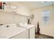 Laundry room with washer, dryer, and shelving at 29460 N 123Rd Gln, Peoria, AZ 85383
