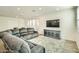 Spacious living room with sectional sofa and large TV at 29460 N 123Rd Gln, Peoria, AZ 85383
