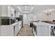 Modern kitchen with white cabinets, quartz countertops, and stainless steel appliances at 3125 W Loma Ln, Phoenix, AZ 85051