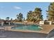 Community pool with surrounding trees and benches at 3125 W Loma Ln, Phoenix, AZ 85051