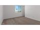 Well-lit bedroom with carpeted floors and a window at 31550 N Hayweather Ln, San Tan Valley, AZ 85143