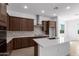 Modern kitchen with dark wood cabinets and white countertops at 31550 N Hayweather Ln, San Tan Valley, AZ 85143