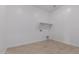 Bright laundry room with built-in shelving and tile floor at 31550 N Hayweather Ln, San Tan Valley, AZ 85143