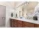 Bathroom with double sinks, large mirror, and a walk-in shower at 31825 N 141St St, Scottsdale, AZ 85262