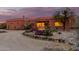 Desert landscape surrounds this stucco home with large windows at sunset at 31825 N 141St St, Scottsdale, AZ 85262