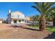 Two-story house with a backyard pool, putting green, and mature palm trees at 3212 N 109Th Ave, Avondale, AZ 85392