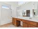 Bathroom with double vanity, large mirror, and tub at 3212 N 109Th Ave, Avondale, AZ 85392