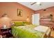 Bedroom with olive green bedding, ceiling fan, and terracotta walls at 3317 N 17Th Ave, Phoenix, AZ 85015