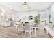 Open concept dining room with white table and chairs, hardwood floors, and chandelier at 3466 E Turnberry Dr, Gilbert, AZ 85298