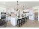 Modern kitchen with an eat-in island, pantry, and stainless steel appliances at 3640 W Josiah Trl, Queen Creek, AZ 85144