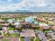 Gorgeous aerial shot of community clubhouse, pool, and lake, set against a mountain backdrop at 42585 W Heavenly Pl, Maricopa, AZ 85138