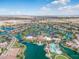 Expansive aerial view of a Primary-planned community featuring lush green spaces and waterways at 42585 W Heavenly Pl, Maricopa, AZ 85138