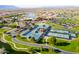 Aerial view of tennis courts within a Primary-planned community surrounded by lush landscaping at 42585 W Heavenly Pl, Maricopa, AZ 85138