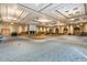 Spacious ballroom featuring a stage, dance floor, and elegant lighting fixtures at 42585 W Heavenly Pl, Maricopa, AZ 85138