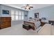 Bright bedroom with large windows and plush carpeting at 42585 W Heavenly Pl, Maricopa, AZ 85138