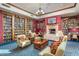 The community library with built-in bookshelves, fireplace, and comfortable furniture at 42585 W Heavenly Pl, Maricopa, AZ 85138