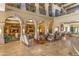 Spacious lobby area with soaring ceilings, comfortable seating, and tiled floors at 42585 W Heavenly Pl, Maricopa, AZ 85138