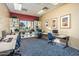 Community computer room with multiple computers, printers, desks, shelves, and comfortable chairs at 42585 W Heavenly Pl, Maricopa, AZ 85138