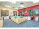 Large craft room with sewing tables, blue patterned carpet, and lots of natural light at 42585 W Heavenly Pl, Maricopa, AZ 85138