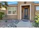 Front entry with decorative wrought iron door and stone accents at 42585 W Heavenly Pl, Maricopa, AZ 85138