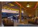 Cozy evening patio with fire pit and string lights at 42585 W Heavenly Pl, Maricopa, AZ 85138