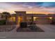 Beautiful desert landscaping surrounds this single-story home with a 3-car garage at 42585 W Heavenly Pl, Maricopa, AZ 85138