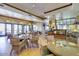 A light-filled cafe interior with ample seating, a beverage area, and large windows at 42585 W Heavenly Pl, Maricopa, AZ 85138