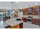 Granite island kitchen with stainless steel appliances and breakfast bar at 42585 W Heavenly Pl, Maricopa, AZ 85138