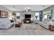 Spacious living room featuring a fireplace and ample natural light at 42585 W Heavenly Pl, Maricopa, AZ 85138