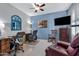 Home office with built-in shelving and comfortable seating at 42585 W Heavenly Pl, Maricopa, AZ 85138