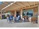 Relaxing patio with fire pit, seating, and pergola at 42585 W Heavenly Pl, Maricopa, AZ 85138