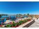 Enjoy lake views from the patio featuring comfortable seating and colorful floral accents at 42585 W Heavenly Pl, Maricopa, AZ 85138