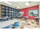 Clean and bright recreation room with tables, chairs, display shelves, and lots of natural light at 42585 W Heavenly Pl, Maricopa, AZ 85138