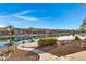 Tranquil waterfront view with homes and landscaping at 42585 W Heavenly Pl, Maricopa, AZ 85138