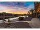 Scenic waterfront view at sunset with homes at 42585 W Heavenly Pl, Maricopa, AZ 85138