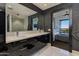 Elegant bathroom with double vanity, marble floors, and a view of bedroom at 4422 N 75Th St # 7011, Scottsdale, AZ 85251