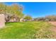 Green grassy backyard with mature trees at 49587 W Mayer Blvd, Maricopa, AZ 85139