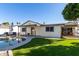 Home exterior view with pool and grassy area at 5266 E Blanche Dr, Scottsdale, AZ 85254