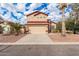 Two-story house with tan exterior, red accents, and a two-car garage at 6928 E Four Peaks Way, Florence, AZ 85132