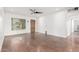 Bright living room showcasing wood-look tile floors, modern ceiling fan, and a window with natural light at 909 W Marshall Ave, Phoenix, AZ 85013