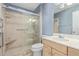 Bathroom boasts a shower/tub combo, vanity, and tiled walls at 9459 N 111Th Ave, Sun City, AZ 85351