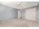 Well-lit bedroom with carpet, ceiling fan, and access to hallway at 9459 N 111Th Ave, Sun City, AZ 85351