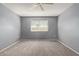 Spacious bedroom featuring carpet, a ceiling fan and window with blinds at 9459 N 111Th Ave, Sun City, AZ 85351